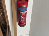 a fire extinguisor attached to the wall of a room