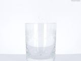 a glass of water sitting on a white surface