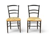 pair of black painted chairs with floral upholstered seat cushions