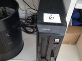 a black desktop computer sitting on a desk next to a trash can