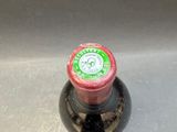 a close up of a bottle of beer on a sink