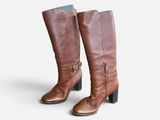 tall brown leather boots with buckles on the side