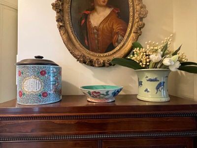 a picture of a painting on the wall above a dresser