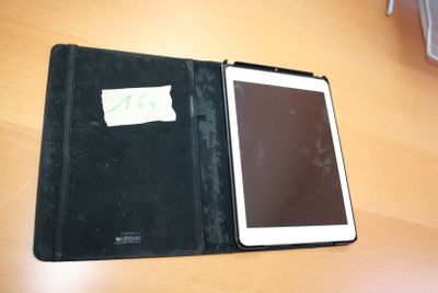 a tablet that is sitting on a table with a notepad