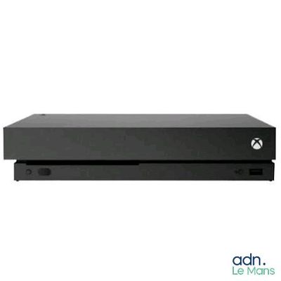 a black xbox console sitting on top of a white surface