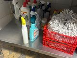 many cleaning supplies on the shelf in the kitchen