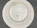 a white plate with writing on it sitting on a table