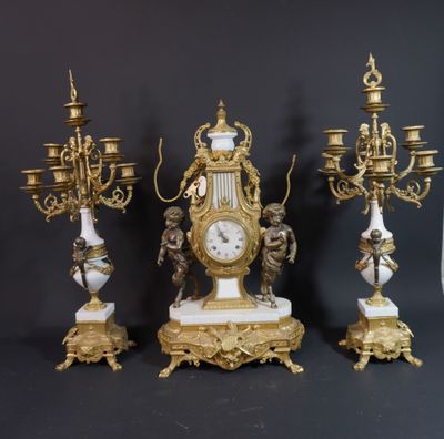 three antique clocks are sitting next to each other on a table