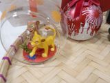 a small christmas ornament with a dog inside of it on a table