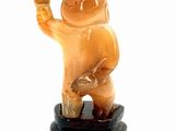 a figurine of a man holding a banana in his hand