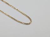 a gold necklace with a chain on a white background