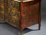 an image of a red and gold chest of drawers on a grey background