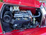 a red car with an engine in the trunk