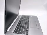 a silver laptop with a black keyboard on a white surface