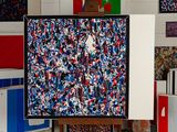 a picture of a painting on a easel in front of a bunch of boxes