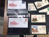 a lot of stamps on a table with a laptop on it