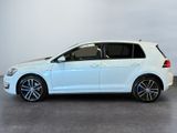the white volkswagen golf is parked in a large room