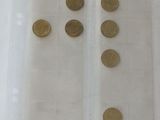 a lot of coins in a plastic bag on a table