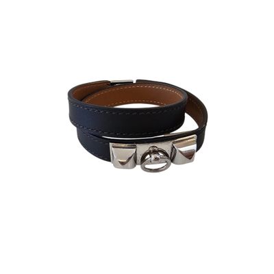 a close up of a black leather bracelet on a white background
