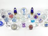 a lot of glass marbles on a white surface