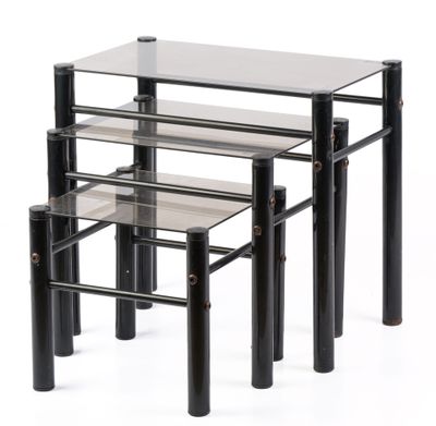 three glass tables with metal legs and a glass top