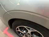 a close up of a car tire with a sticker on it