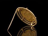 an image of a close up of a gold coin on a black surface
