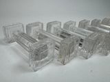 six pieces of clear glass on a white surface