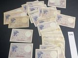 several bills of different currency laid out on top of a table
