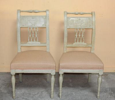 pair of antique chairs with upholstered backs and upholstered seat cushions