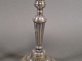 a silver candle that is sitting on a table