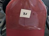 a red chair with a sticker on it in a gym
