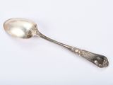 a spoon that is sitting on a white surface