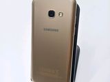 the back of a gold samsung galaxy s6 phone with a black stand