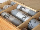 a wooden box filled with bottles of wine on top of a wooden table