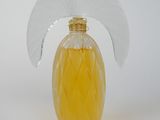 yellow perfume bottle with a white fan on top of it