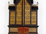a wooden cabinet with a gold and black design on it