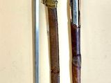 two different types of swords on a white surface