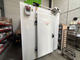 an image of a large white freezer in a warehouse