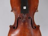 an old violin is being held up by a person