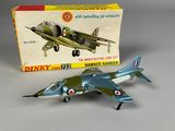 a toy airplane that is sitting next to a box