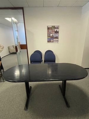 une photo d'une salle de réunion avec des chaises et une table