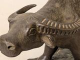a statue of a bull that is standing on a rock