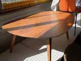 a table and chairs in a room with a window in the background