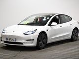 the white tesla model 3 is parked on a checkered floor