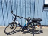 a bike that is parked next to a blue building