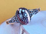 a close up of a silver ring with a stone in it
