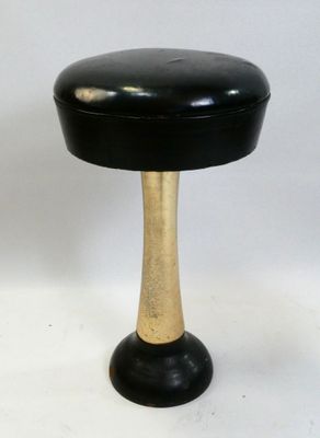 an image of a black and gold stool on a white background