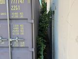an image of a shipping container in a narrow alley