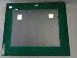green picture frame with a hole in the middle of it on a table